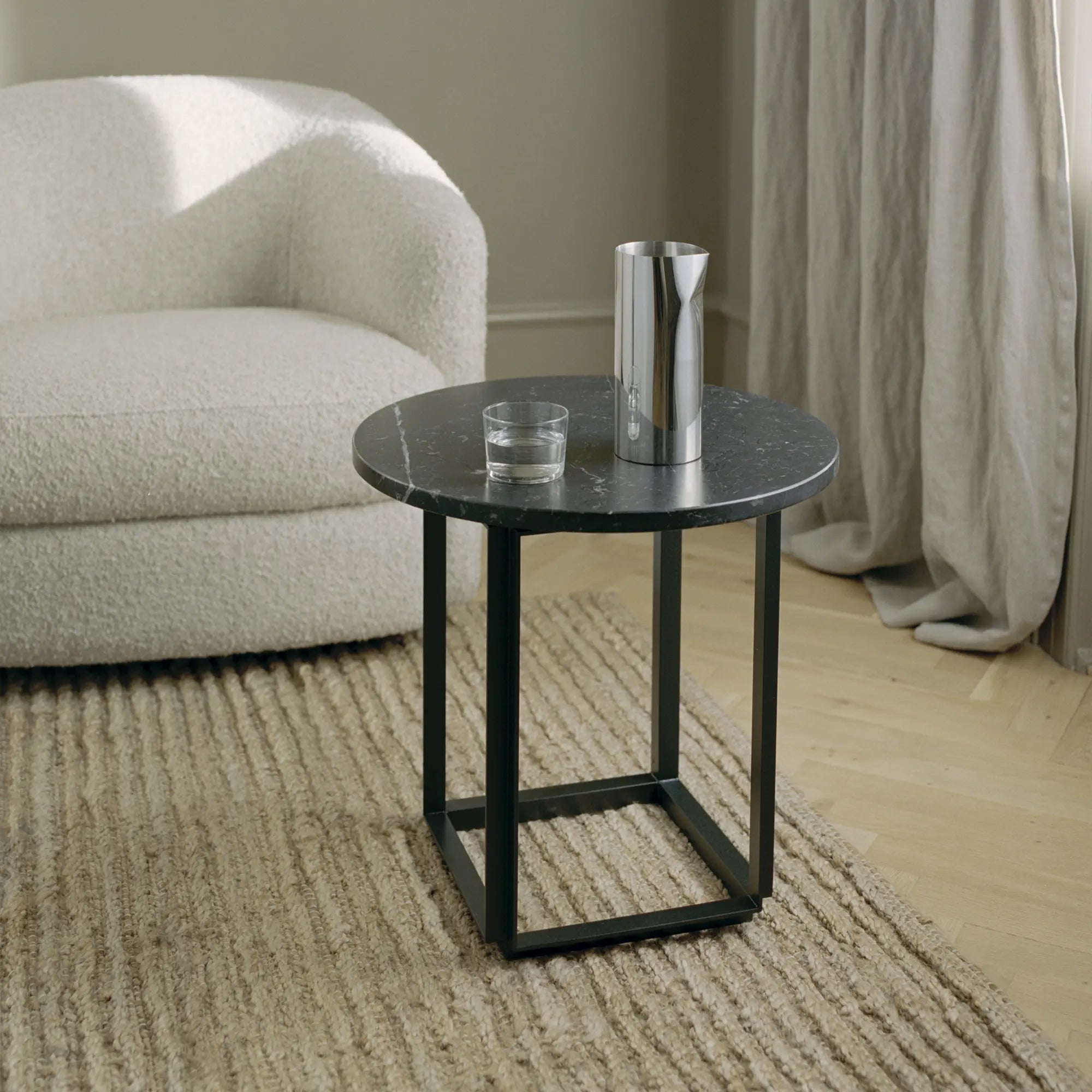 Pleat Pitcher on dining table, showcasing its modern and sophisticated design