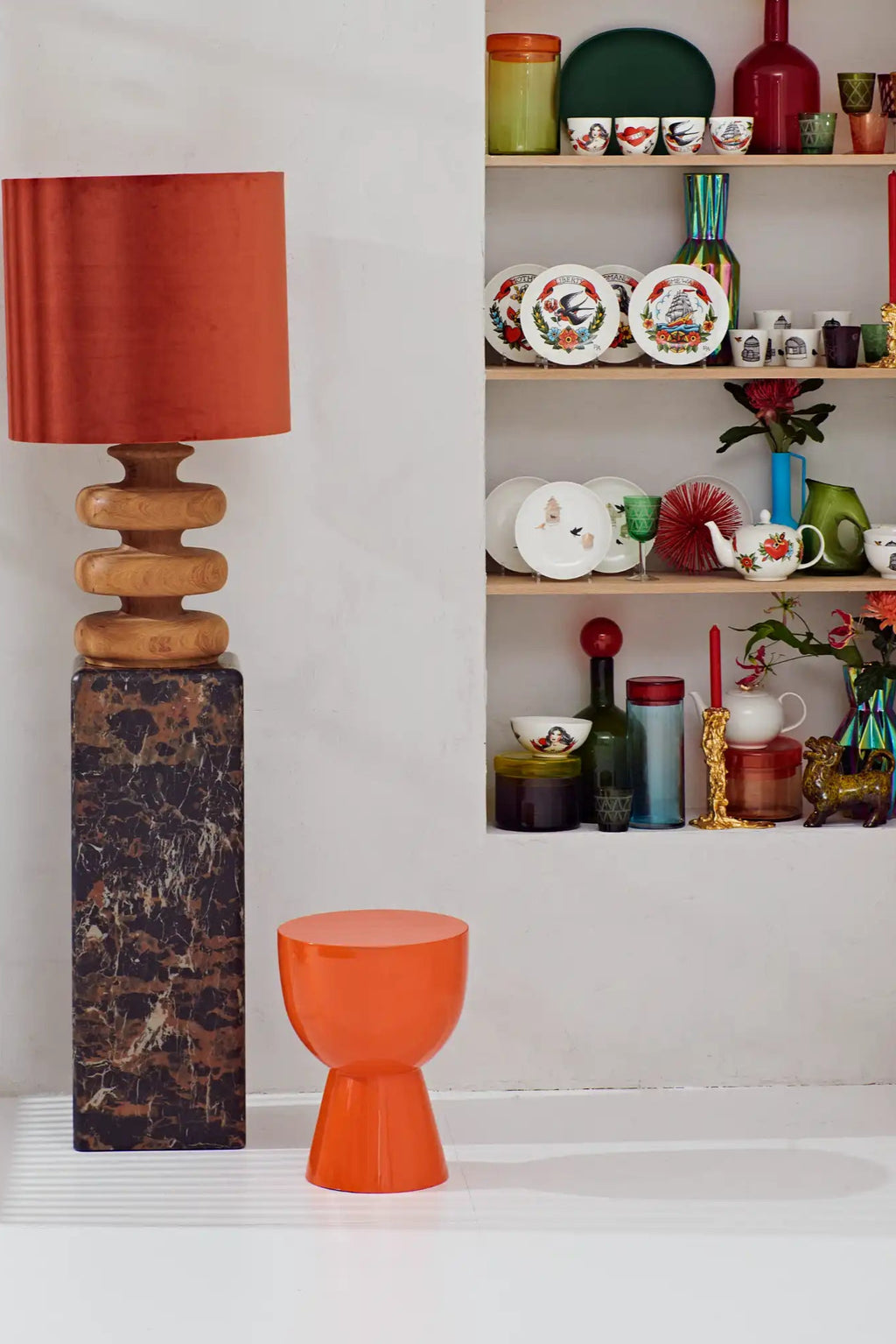 POLSPOTTEN Tip Tap Stool, a vibrant orange sculptural stool crafted from glossy lacquered polyresin with a distinctive hourglass silhouette featuring a rounded top and a flared base. This modern minimalist stool offers a playful pop of color and serves as a versatile accent piece or side table for contemporary living rooms, bedrooms, or creative interiors.