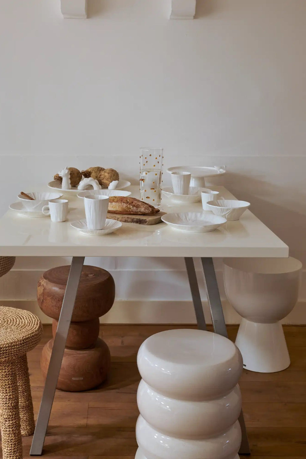 POLSPOTTEN Tip Tap Stool, a sculptural and playful accent stool crafted from glossy cream white ceramic with a smooth, rounded finish. Its unique design features three stacked, bobble-like forms, creating an organic modern and contemporary silhouette. Perfect as a chic side table or decorative accent stool for modern living rooms, bedrooms, or entryways.