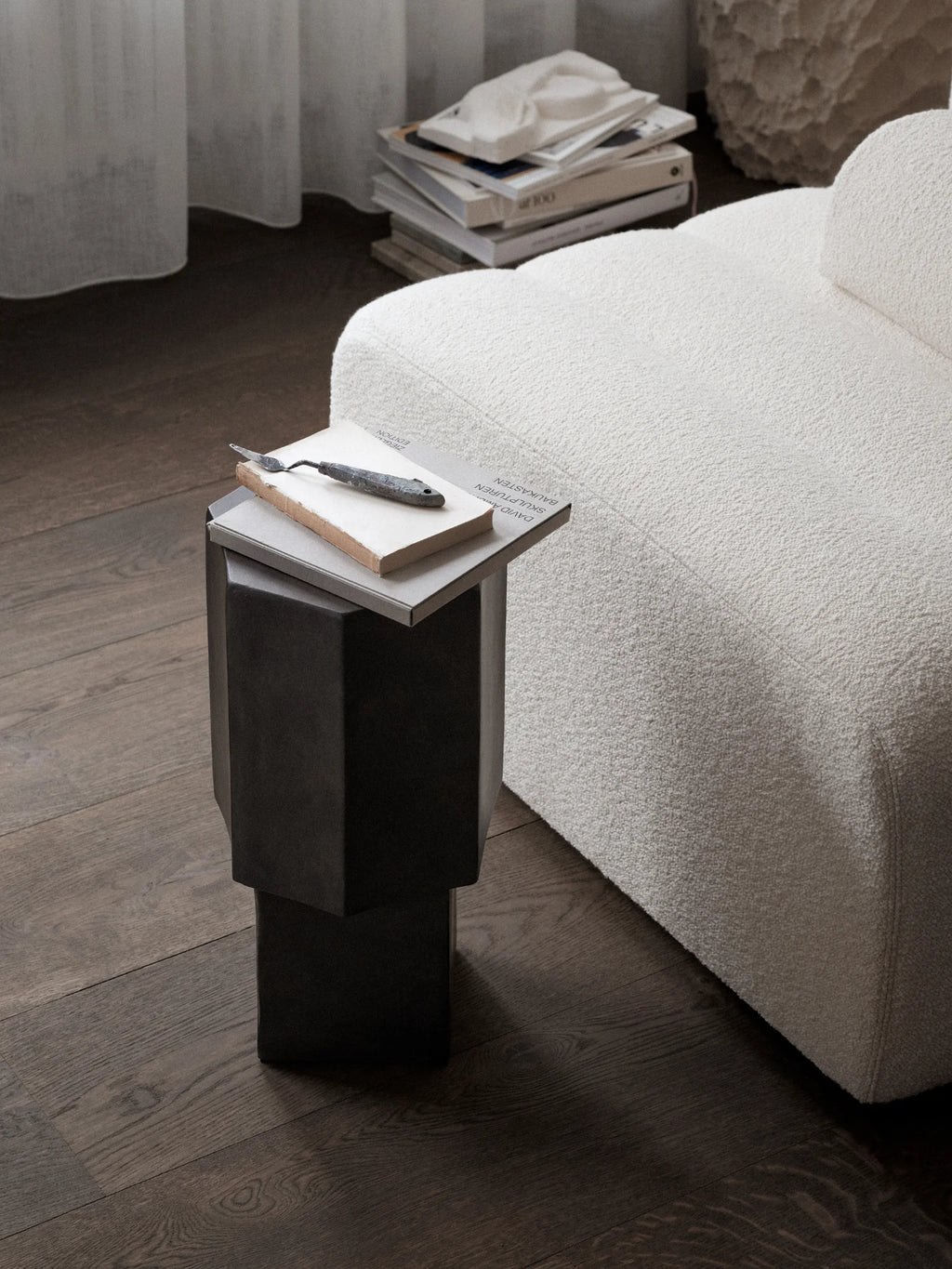 NORR11 Quartz Side Table, a modern and elegant hexagonal side table in a dark, charcoal quartz finish. Its geometric, stacked design provides a stylish, durable surface. Perfect for contemporary living spaces, this luxury table complements minimalist decor.