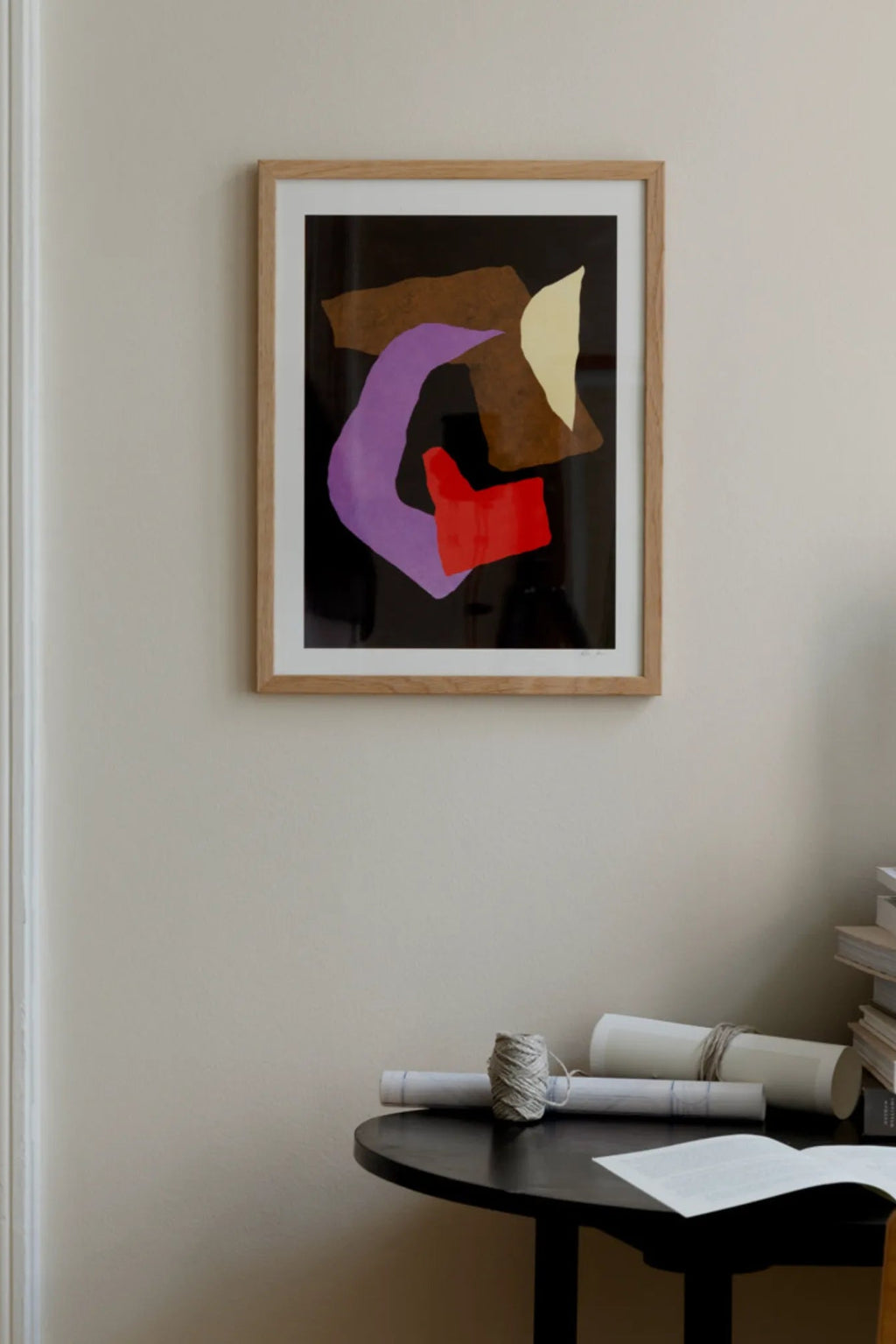 The Poster Club Blind Eye no. 04, a contemporary abstract art print featuring bold graphic shapes in vibrant purple, red, brown, and yellow against a striking black background. This modern wall art is elegantly framed with a light natural oak frame and a crisp white mat, enhancing its visual impact. Ideal for adding a pop of color to contemporary gallery walls, modern living rooms, or stylish bedrooms.