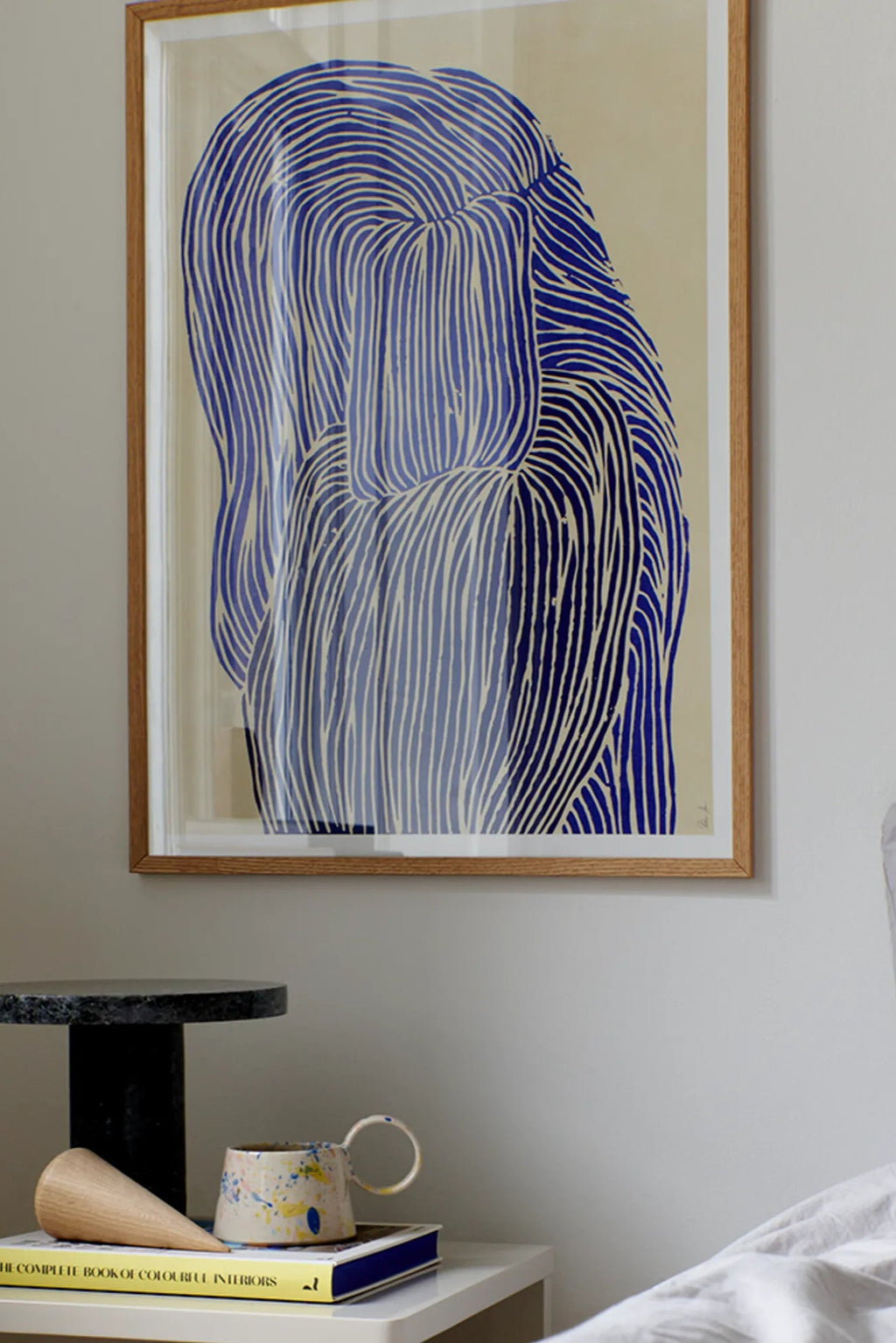 The Poster Club Deep Blue, an abstract art print featuring a composition of flowing organic lines in varying shades of deep blue against a soft cream background, creating a mesmerizing visual texture. This framed art print is encased in a natural oak frame with a clean, minimalist profile, ideal as contemporary wall art for modern minimalist interiors, Scandinavian living rooms, or serene bedroom accents.