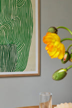 Close-up of a refreshing Green Ocean drink in a glass with ice cubes and mint leaves on a wooden table