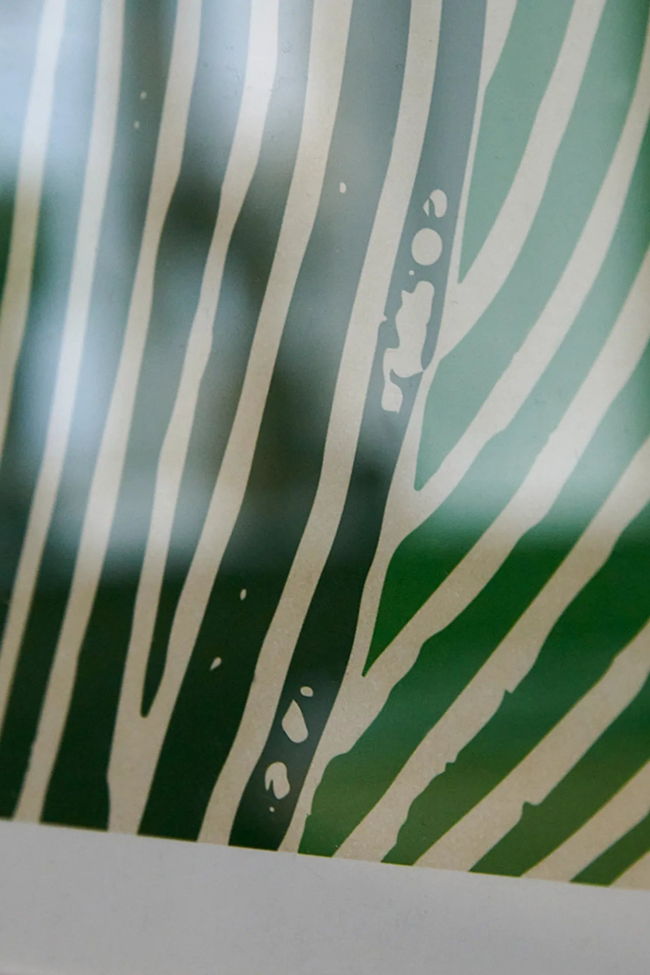 A woman holding a bottle of Green Ocean smoothie with tropical fruits and green vegetables