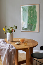  Aerial view of a vibrant Green Ocean juice in a mason jar with a straw and slices of kiwi and cucumber
