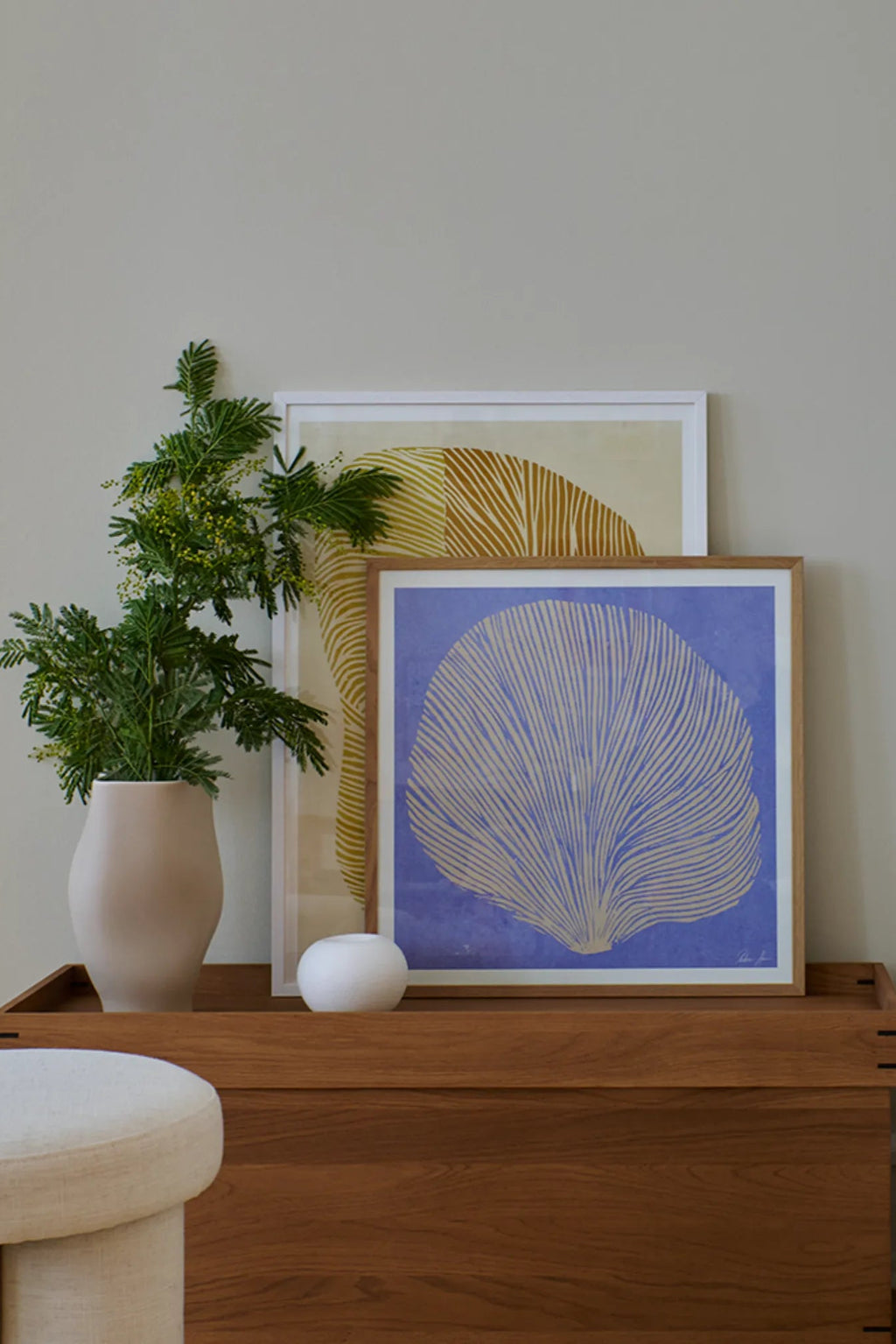 The Poster Club Sea Lavender, a captivating abstract art print featuring delicate organic line art in an off-white or beige hue, resembling a sea fan or coral, set against a vibrant royal blue background. This contemporary poster is presented in a natural oak frame, embodying a minimalist and organic modern aesthetic. Perfect for adding a touch of coastal abstract art to living rooms, bedrooms, or modern gallery walls.