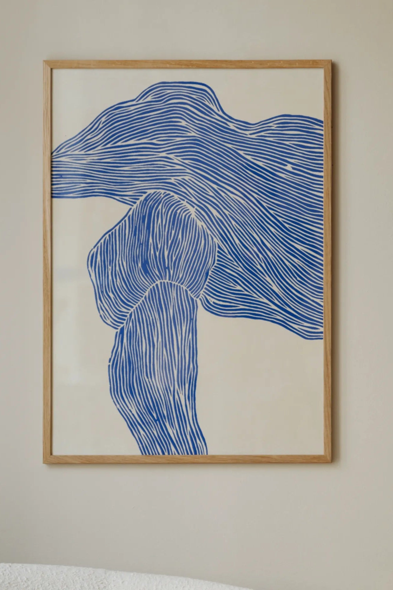 The Line – Navy blazer styled with a white blouse and statement necklace