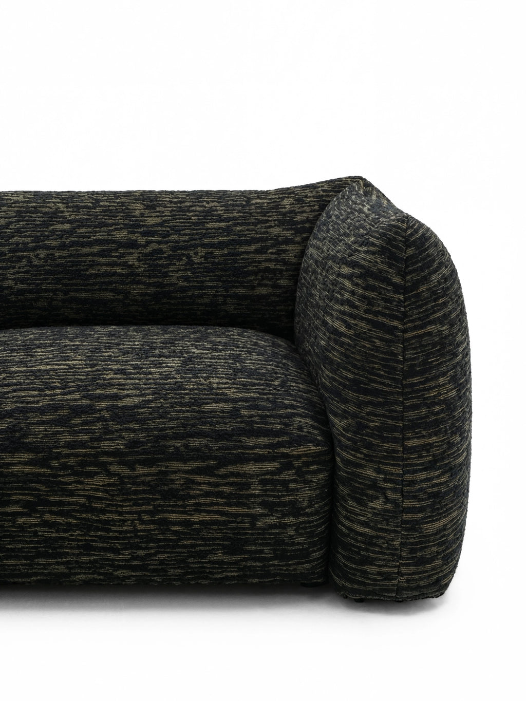TCL Studios Rèverie Sofa, a contemporary organic modern sofa featuring plush, rounded lines and a sculptural silhouette, upholstered in a richly textured black and gold woven fabric. This luxurious bouclé-style couch offers deep comfort and a sophisticated aesthetic, perfect as a statement piece for modern minimalist living rooms or inviting contemporary spaces.