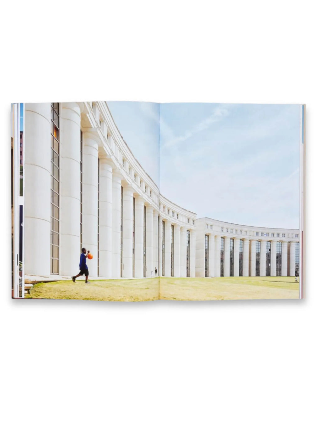 Book Ricardo Bofill, an open art and architecture book displaying a large, curved building with classical white columns and modern glass windows against a bright blue sky. This aesthetic architectural photography book is perfect for design enthusiasts and students of architectural history.