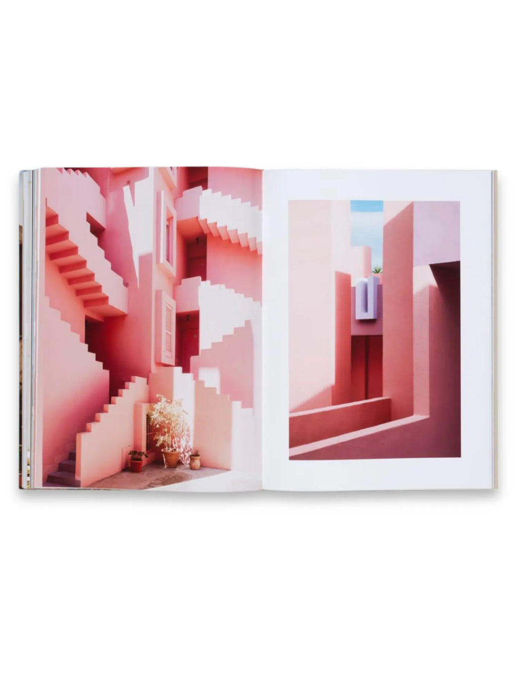 Book Ricardo Bofill, an open art book showcasing vibrant architectural photography with two pages displaying pink and coral-colored geometric buildings and staircases under bright sunlight. This stunning coffee table book is perfect for architecture enthusiasts and design lovers.