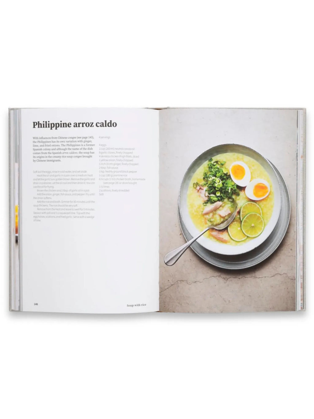 Book Rice and Shine, an open cookbook featuring the "Philippine arroz caldo" recipe with a vibrant food photograph on the right page. The creamy yellow rice porridge, garnished with green scallions, halved hard-boiled eggs showing bright orange yolks, and fresh green lime slices, is presented in a grey ceramic bowl. This detailed recipe book is perfect for home chefs exploring authentic Asian cuisine and cultural dishes.