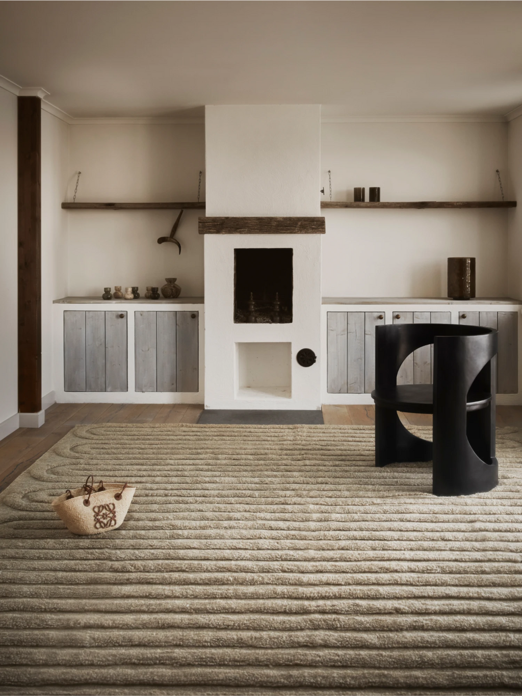 Tinted Objects Riklund Wool Rug, a luxurious beige wool area rug with a distinctive ribbed texture and subtle curved patterns. This premium hand-tufted rug adds warmth and modern elegance to any living space, ideal for design-conscious homeowners seeking a stylish floor covering.