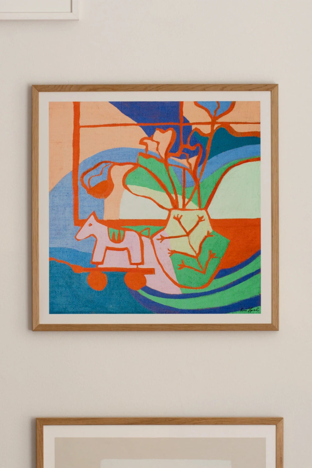 The Poster Club Fini, a vibrant abstract art print featuring bold organic shapes in a lively palette of coral orange, royal blue, teal, green, and pink, depicting a stylized vase and a toy horse. This modern wall art piece is framed in a light natural oak frame with a crisp white mat. Perfect for contemporary gallery walls, playful living rooms, or creative kids' bedroom decor.
