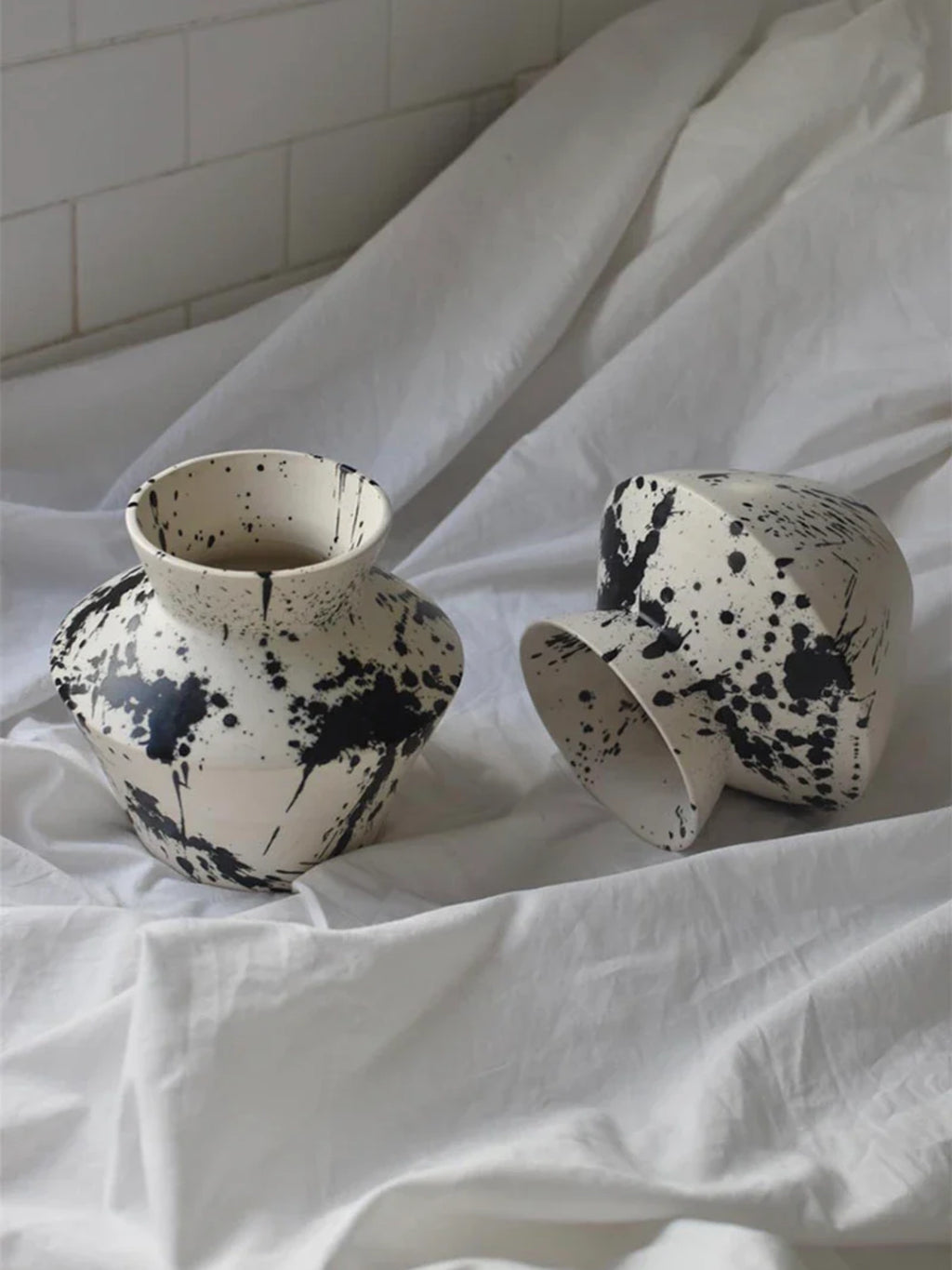 OWO Ceramics x That Cool Living Rock Vase I, a handcrafted ceramic vase with a modern splatter glaze. This premium, stylish vase adds an artistic touch to any space. Perfect for those who appreciate unique, elegant home decor.