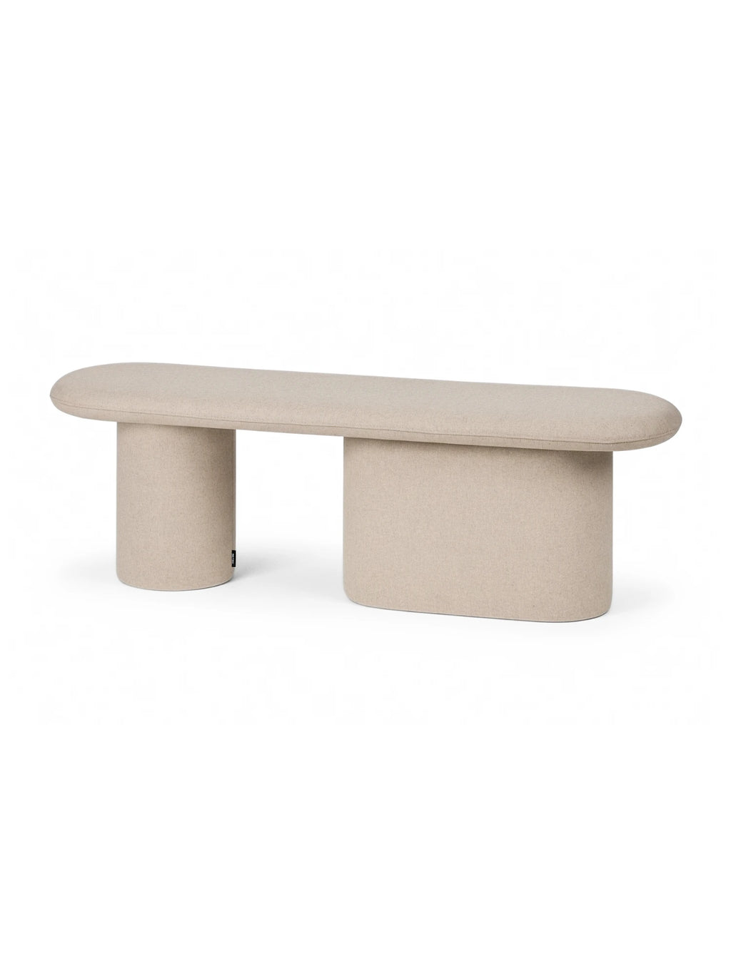noo.ma Rull Bench, a contemporary organic modern bench featuring an elongated oval top and two distinctive sculptural bases, all fully upholstered in a soft, textured light beige fabric. Its minimalist design showcases one cylindrical and one rounded rectangular support, creating a unique visual balance perfect for adding a refined touch to Scandinavian living rooms, modern entryways, or minimalist bedrooms.