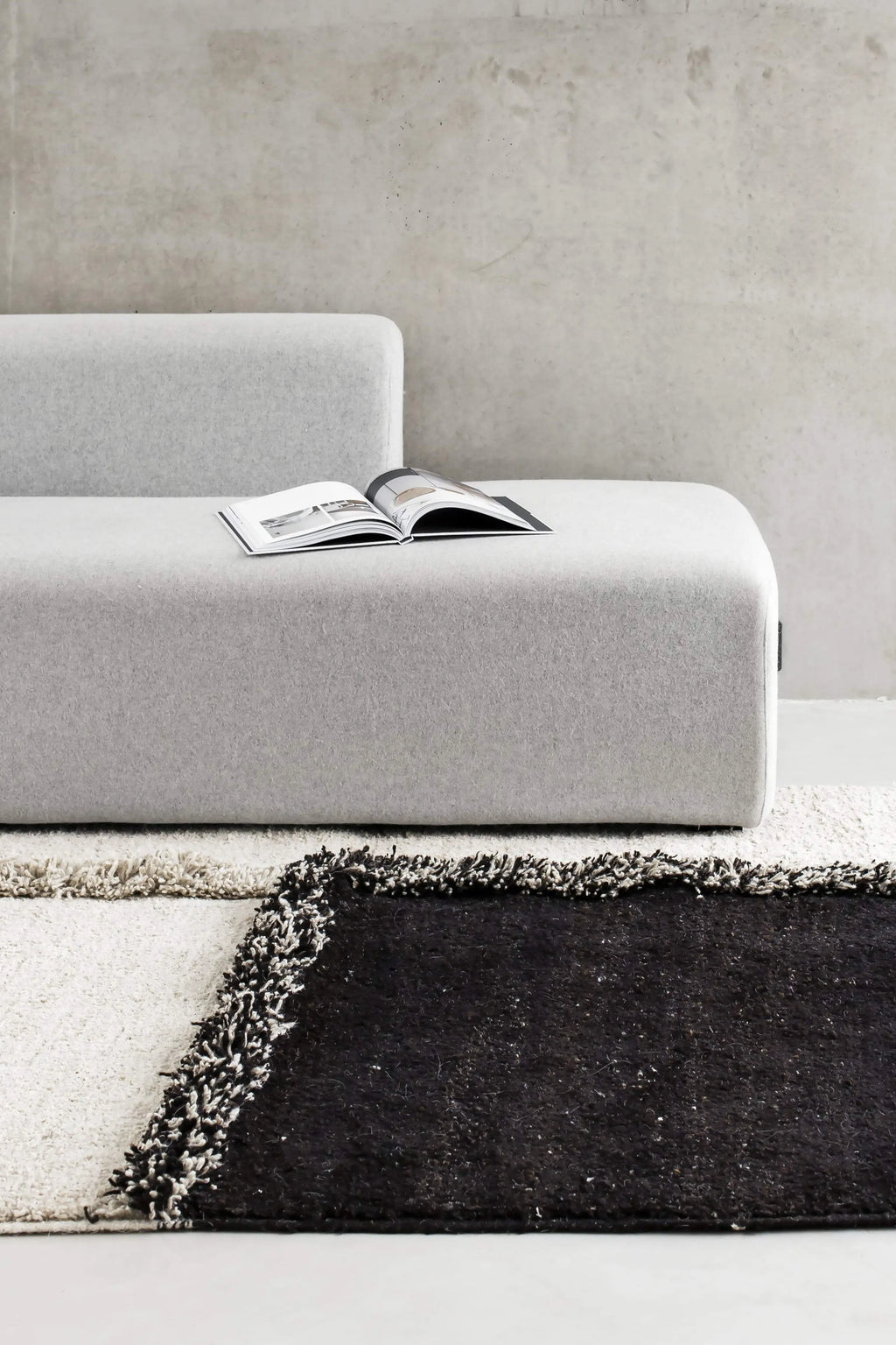 Sera Helsinki E-1027 Wool Rug, a luxurious hand-knotted wool area rug featuring a striking geometric pattern with deep, plush shaggy pile in contrasting natural cream and dark brown tones. This modern minimalist rug is ideal for adding warmth and texture to Scandinavian living rooms, contemporary bedrooms, or organic modern spaces.