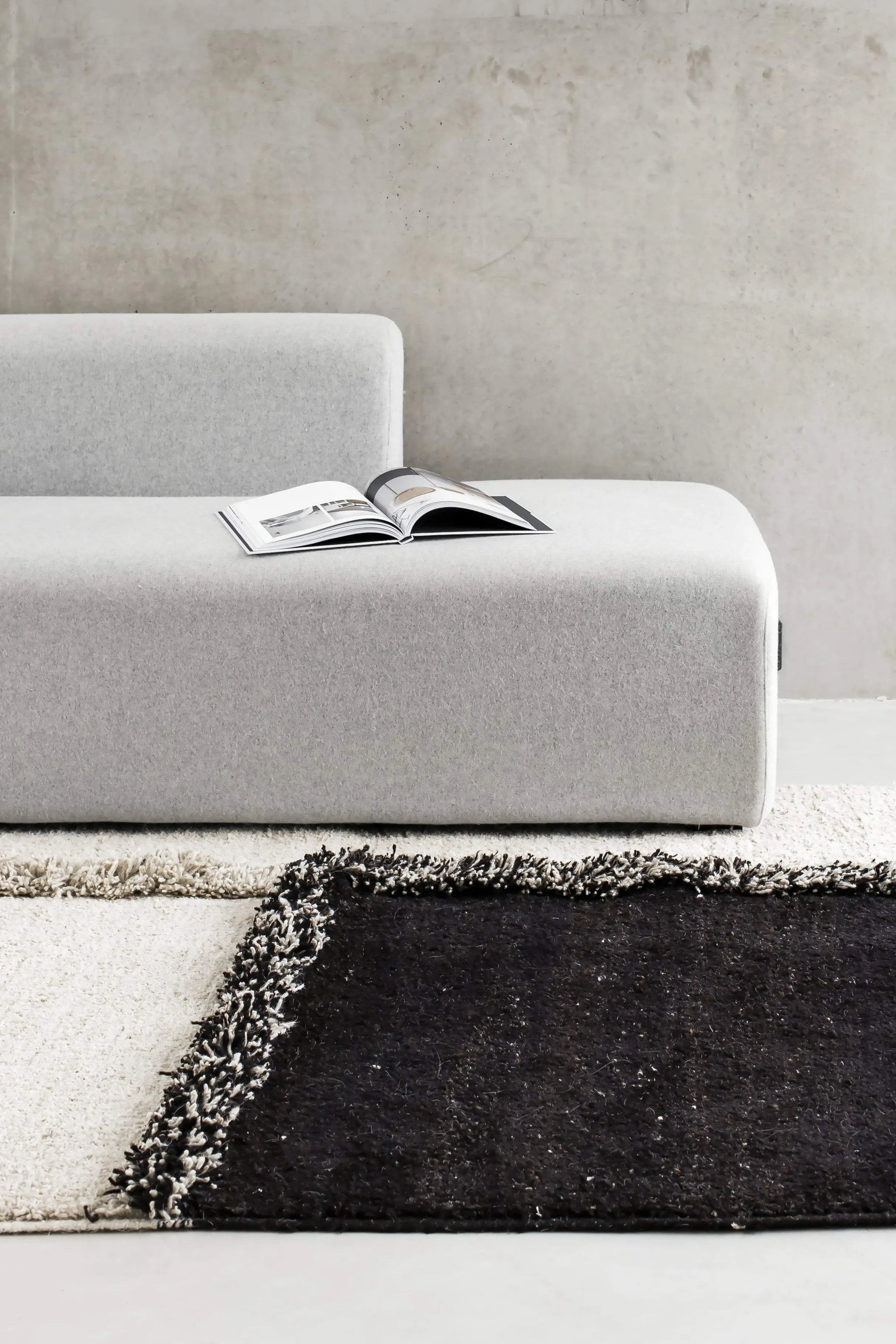 Sera Helsinki E-1027 Wool Rug, a luxurious hand-knotted wool area rug featuring a striking geometric pattern with deep, plush shaggy pile in contrasting natural cream and dark brown tones. This modern minimalist rug is ideal for adding warmth and texture to Scandinavian living rooms, contemporary bedrooms, or organic modern spaces.