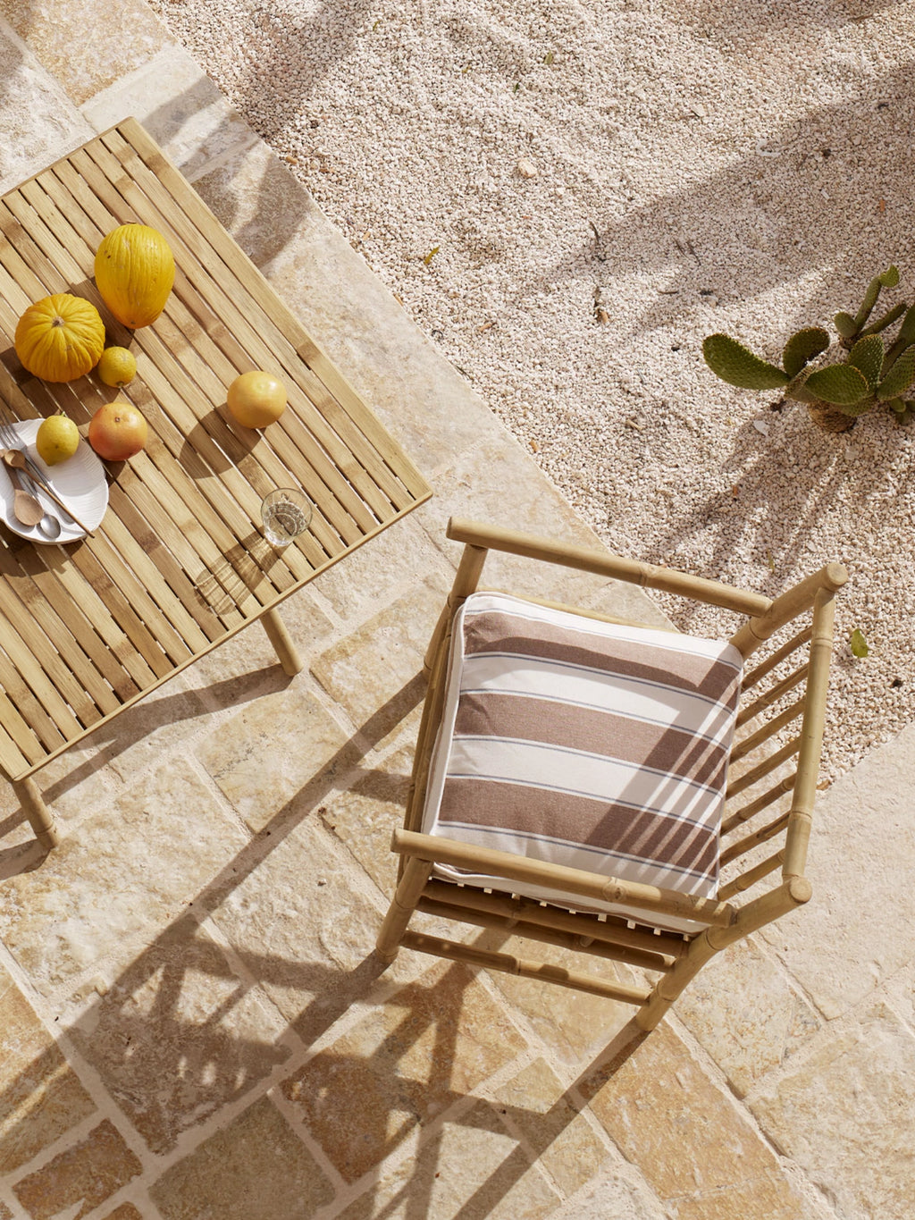 Tine K Outdoor Bamboo Dining Chair With Armrest - Set of 4, a natural bamboo outdoor chair featuring a sturdy slatted backrest and seat, smooth armrests, and a comfortable brown and.