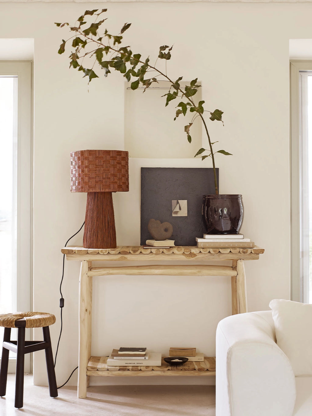 Tine K Kayu Stool, a round accent stool featuring a natural hand-woven rattan top in a light beige tone, contrasted with four sturdy dark brown solid wood legs. This organic modern stool with its textured seat offers a boho-chic aesthetic, blending natural materials and a minimalist form. Ideal as a versatile bedside stool, entryway seat, or stylish small stool for living room accents.