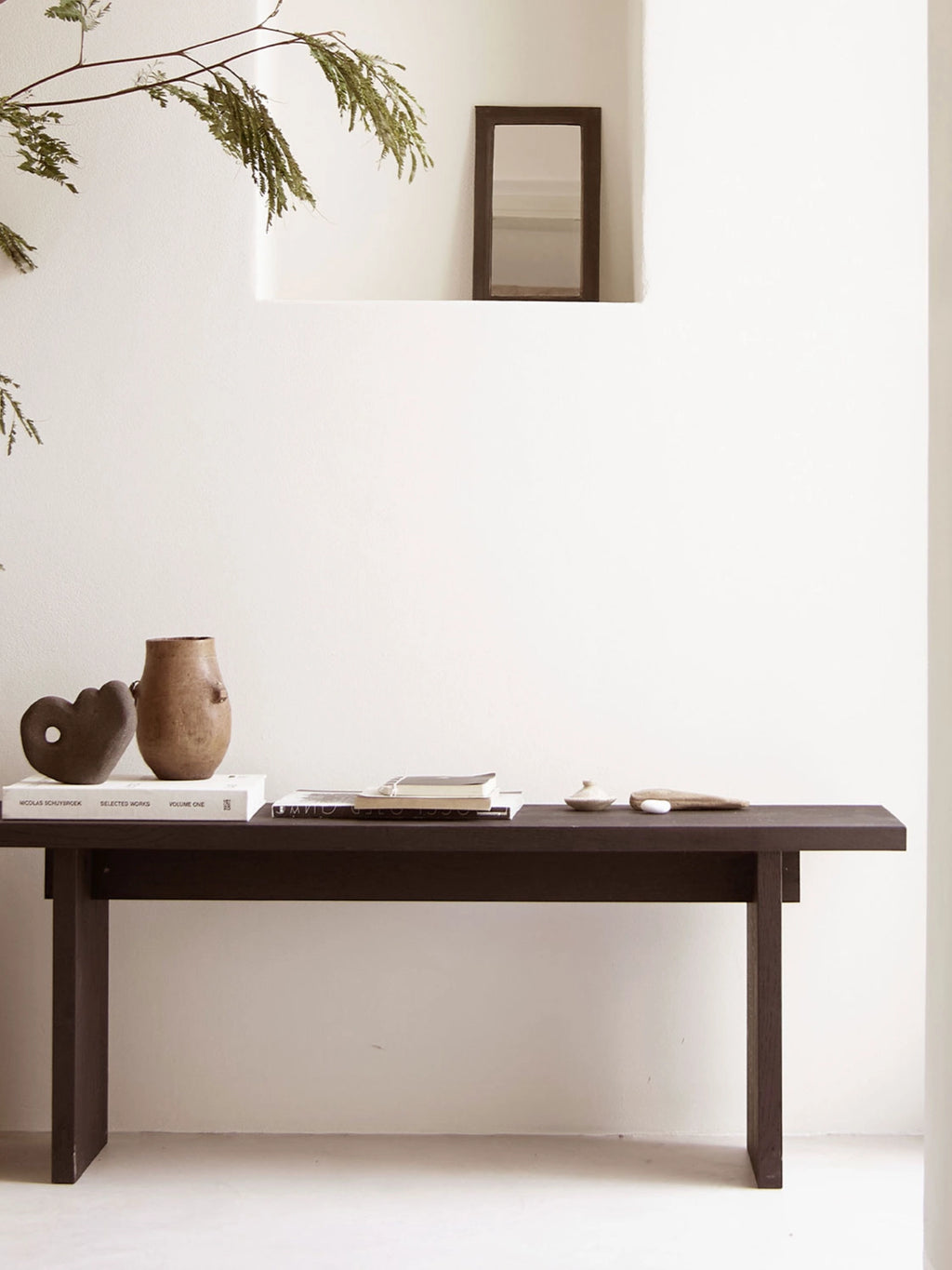 Tine K Koru Bench, a minimalist solid dark wood bench featuring a rich, deep brown matte finish and clean, thick rectangular lines. Crafted from sturdy wood, this contemporary console bench offers a sleek, organic modern aesthetic. Ideal as an entryway console table, dining bench, or accent furniture for Scandinavian and wabi-sabi interiors.