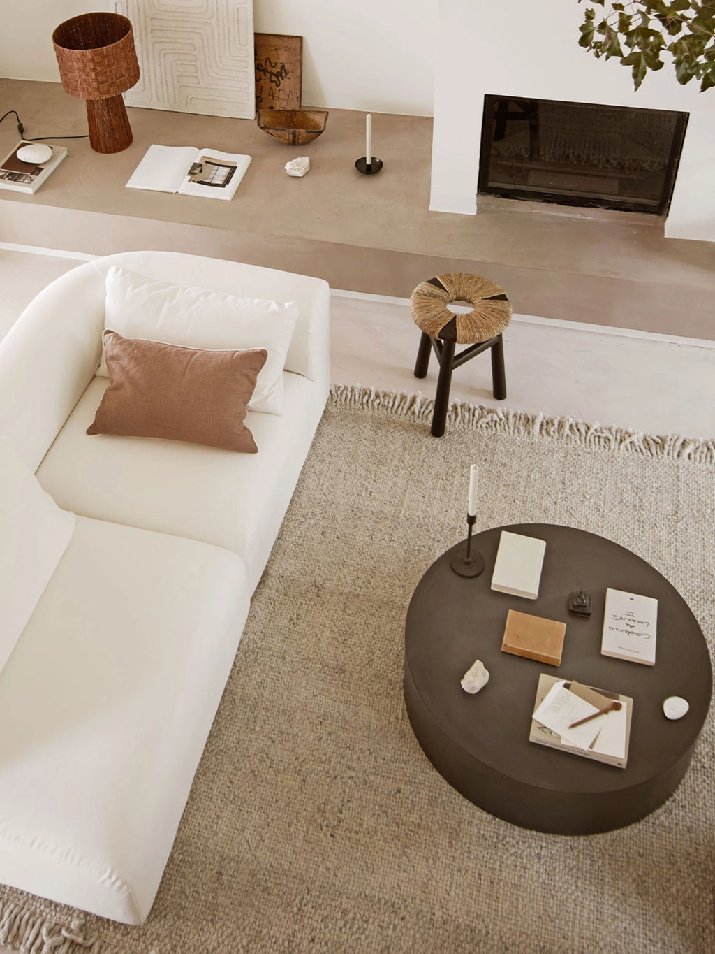 Tine K Kayu Stool, a round organic modern accent stool featuring a hand-wrapped natural jute rope seat in a light beige tone with a dark contrasting stripe, set on sturdy angled dark wood legs. Perfect as a decorative boho stool or extra seating in Scandinavian living rooms and cozy bedrooms.
