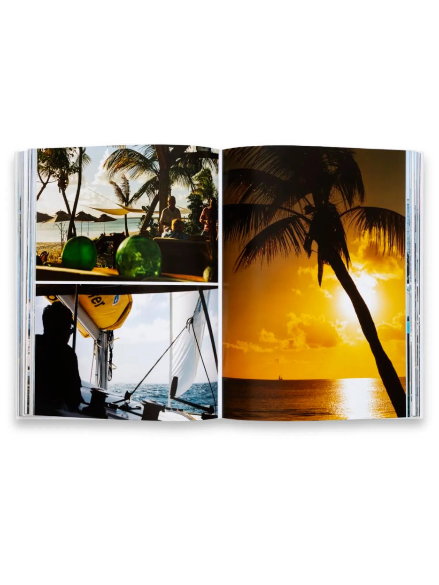 Book Sailing the Seas, an open photography book displaying vibrant tropical scenes. The left page features two images: a top shot of beach umbrellas and people with green decorative objects, and a bottom shot of a sailboat on blue water. The right page shows a stunning golden sunset over the ocean with a silhouetted palm tree. This premium book is perfect for travel enthusiasts and photography collectors seeking inspiring nautical and tropical imagery.