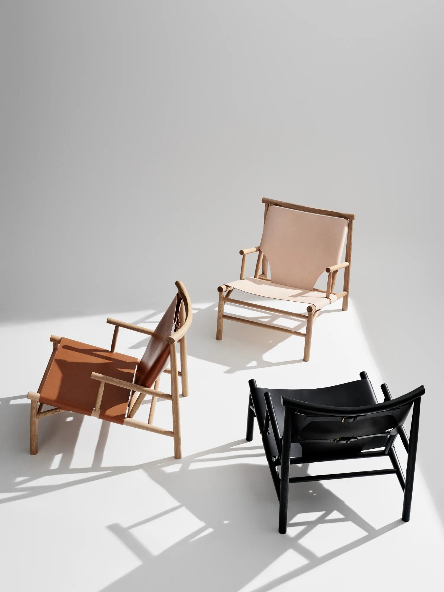 NORR11 Samurai Chair, featuring handcrafted wooden frames and premium leather upholstery in tan, natural, and black finishes. This stylish lounge chair offers a modern yet elegant design, perfect for sophisticated living spaces.