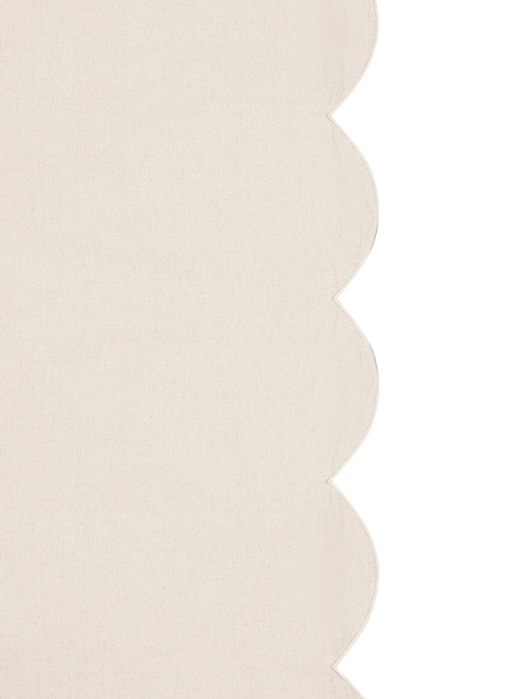 Beige textured fabric with scalloped edge on a white background