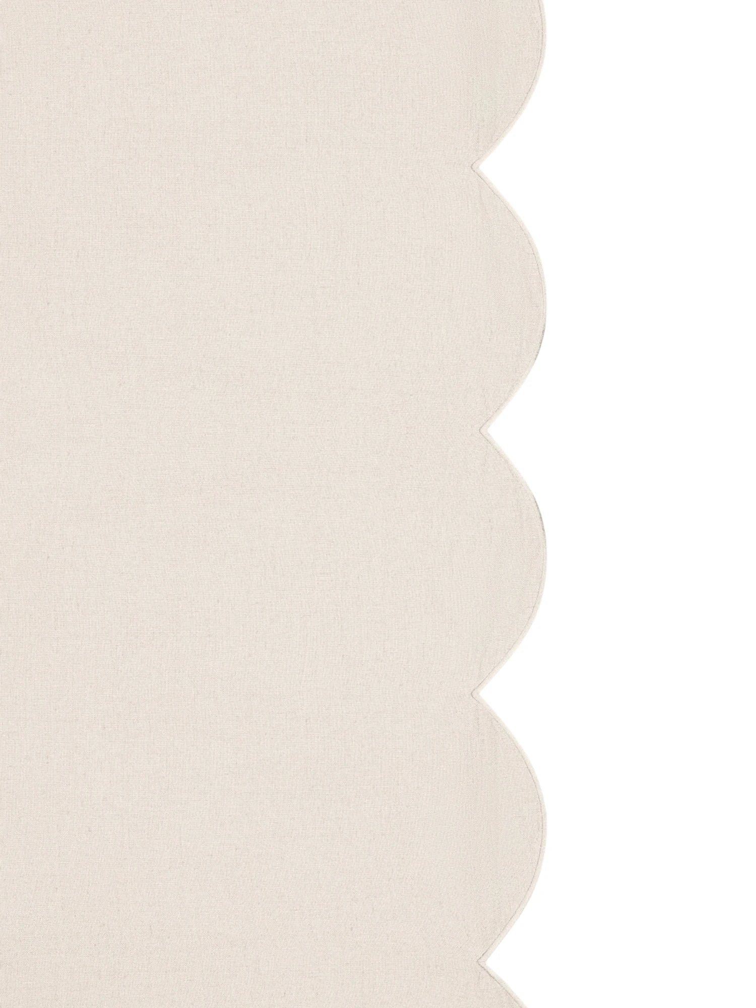 Beige textured fabric with scalloped edge on a white background