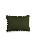Dark green pillow with scalloped edge on a white background