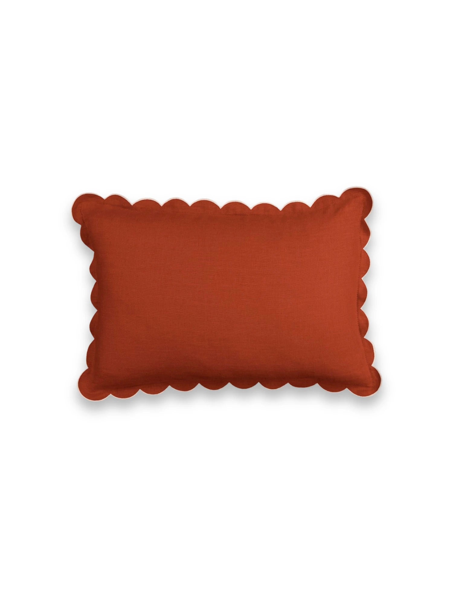Rectangular orange pillow with scalloped edge on a white background