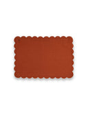 Rectangular placemat with scalloped edge in terracotta color on a white background