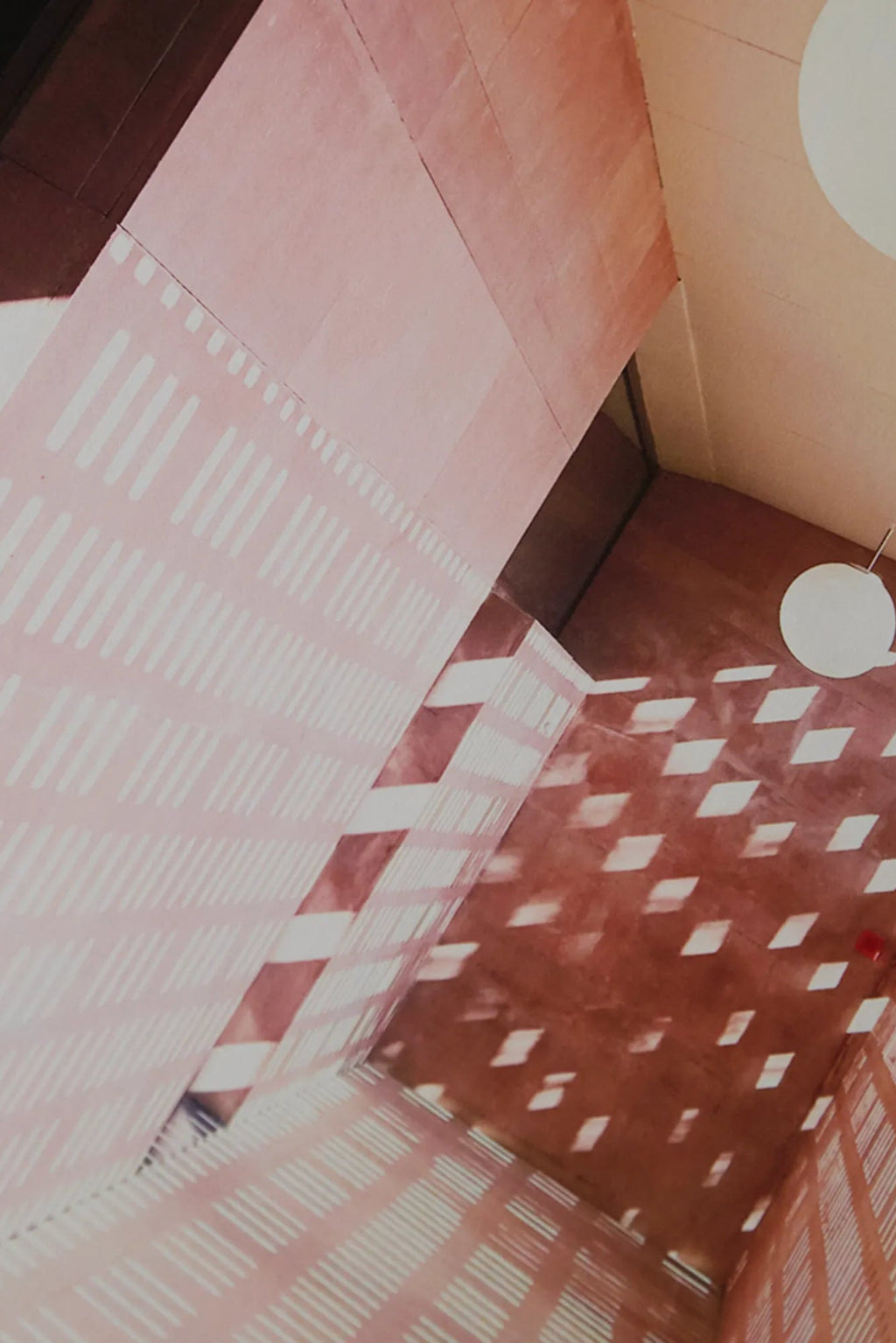 The Poster Club Lights, an abstract architectural art print capturing the dramatic interplay of light and shadow across textured terracotta and blush pink walls. This modern minimalist poster features dynamic geometric patterns of bright white light, creating a striking visual depth and a contemporary aesthetic. Ideal as statement gallery wall art for living rooms, home offices, or bedrooms seeking a unique Brutalist or Mediterranean-inspired design.