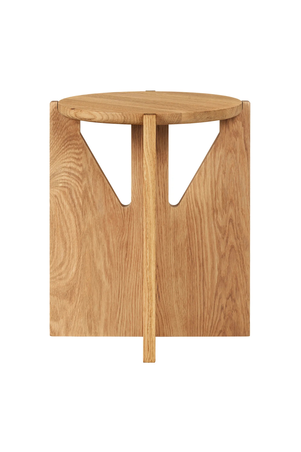 Kristina Dam Simple Stool, a modern minimalist stool crafted from natural solid oak wood with a smooth finish and visible grain. It features a round top supported by two wide, flat geometric legs and a central vertical post.