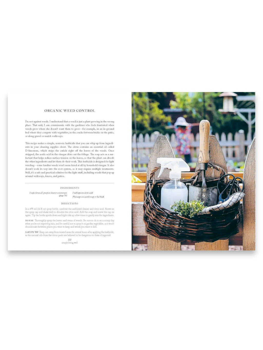 Book Simply Living Well, an open hardcover book displaying a page on "Organic Weed Control" with text on the left and a rustic garden scene on the right. The right page features a woven wicker basket filled with gardening tools like a trowel, pruning shears, a spray bottle, and fresh herbs, resting on a wooden fence with a blurred garden background. This practical guide offers natural living tips and DIY solutions for eco-conscious individuals and home gardeners seeking sustainable practices.