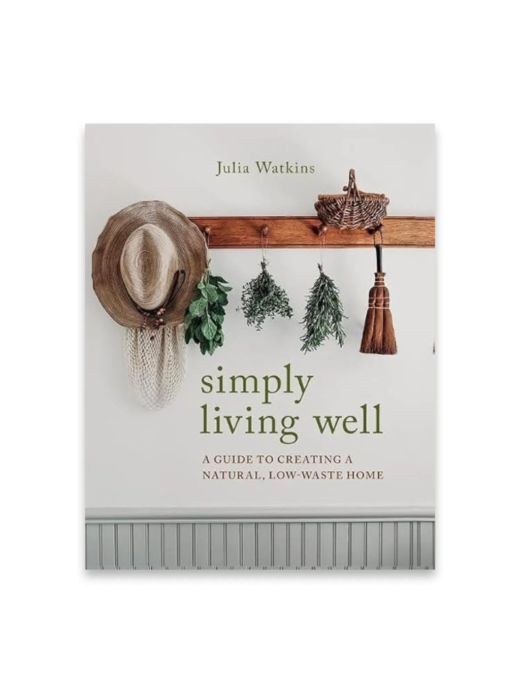 Book Simply Living Well, a natural lifestyle guide with a rustic cover design featuring a straw hat, dried herbs, and a small broom hanging on a wooden rack against a white wall. This book is perfect for eco-conscious readers seeking practical advice on sustainable and low-waste living.