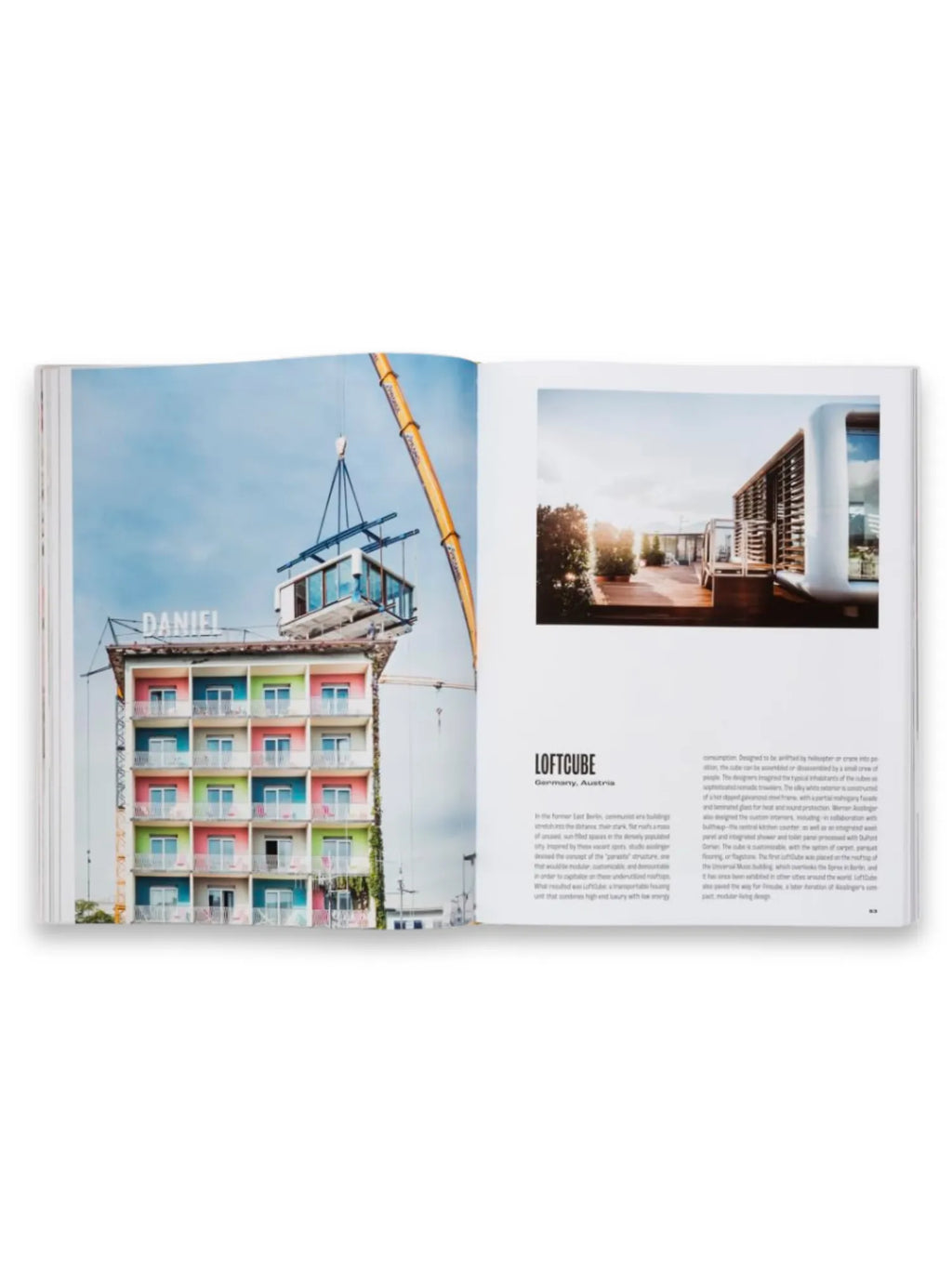 Book Spatial Storytelling, an open book displaying a colorful building with a modular unit being craned onto its roof on the left page, and a modern rooftop living space with text about "LOFTCUBE" on the right. This comprehensive book offers design inspiration and architectural insights for professionals and enthusiasts alike.