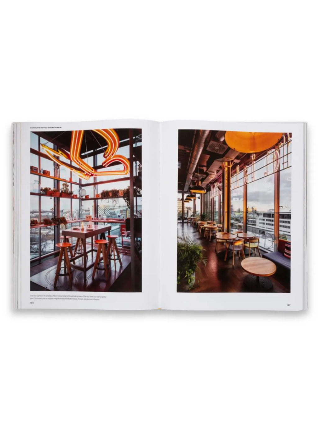 Book Spatial Storytelling, an open book displaying two vibrant interior design photographs on a white background. This coffee table book is ideal for architects, interior designers, and design enthusiasts seeking inspiration and visual narratives.