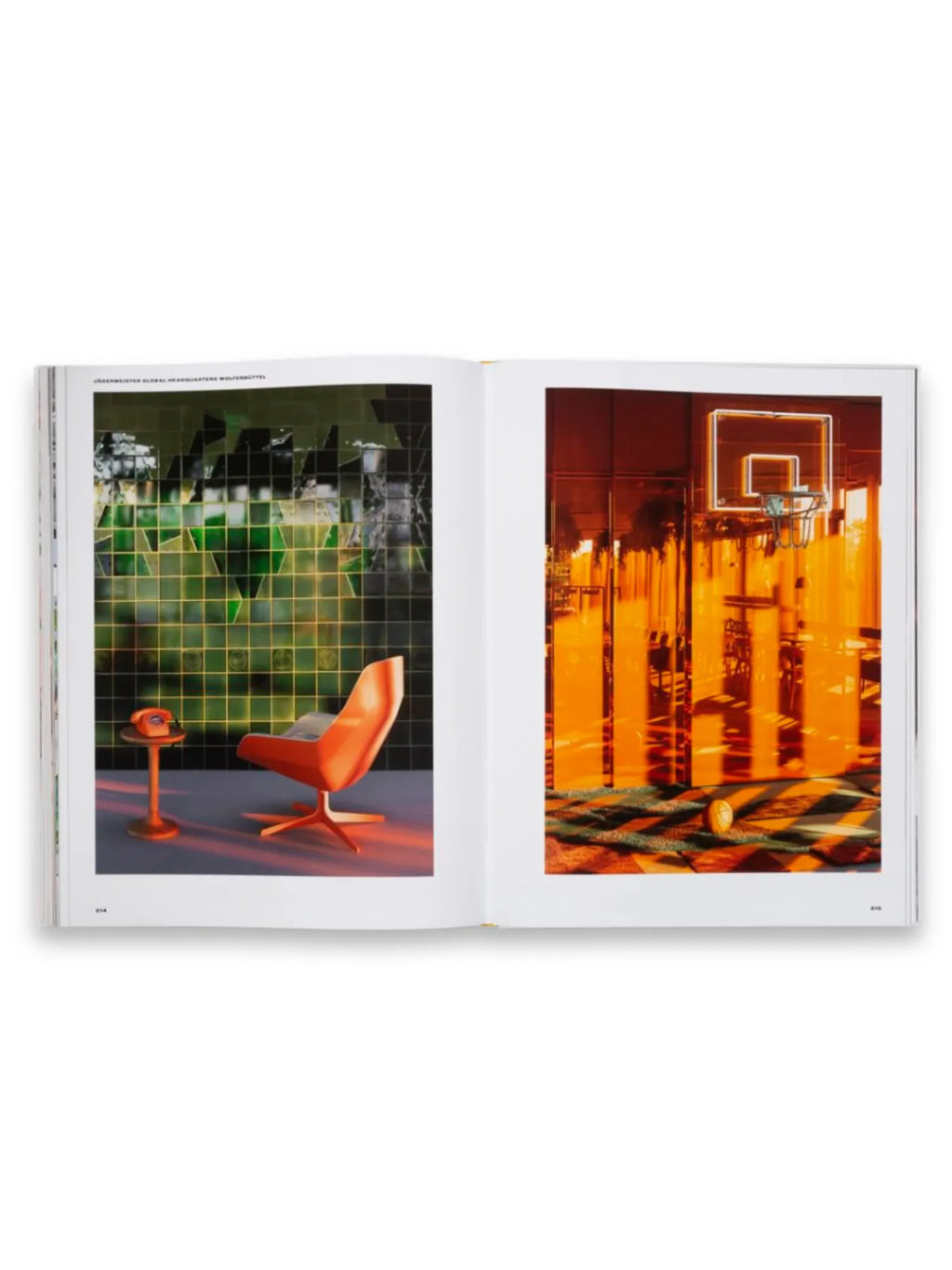Book Spatial Storytelling, an open hardcover book displaying two vibrant, high-contrast interior design photographs. The left page features an orange modern chair and telephone against a green tiled wall; the right page shows a basketball court bathed in warm orange light. This insightful design book is perfect for architects, interior designers, and visual storytelling enthusiasts seeking inspiration.
