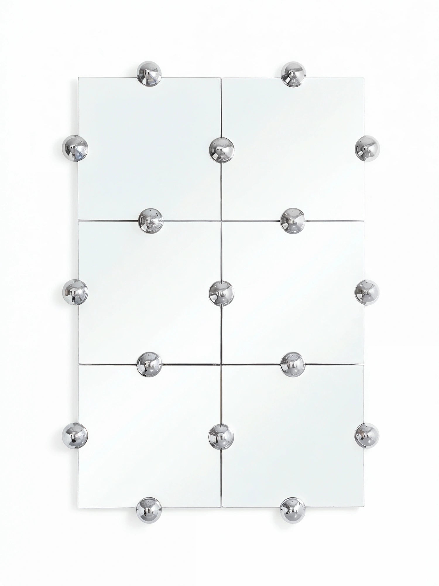 Moustache Sphera Crystal Palace L Vertical Mirror, a large modular mirror composed of six square glass panels, adorned with numerous polished chrome spherical fasteners, on a white wall.