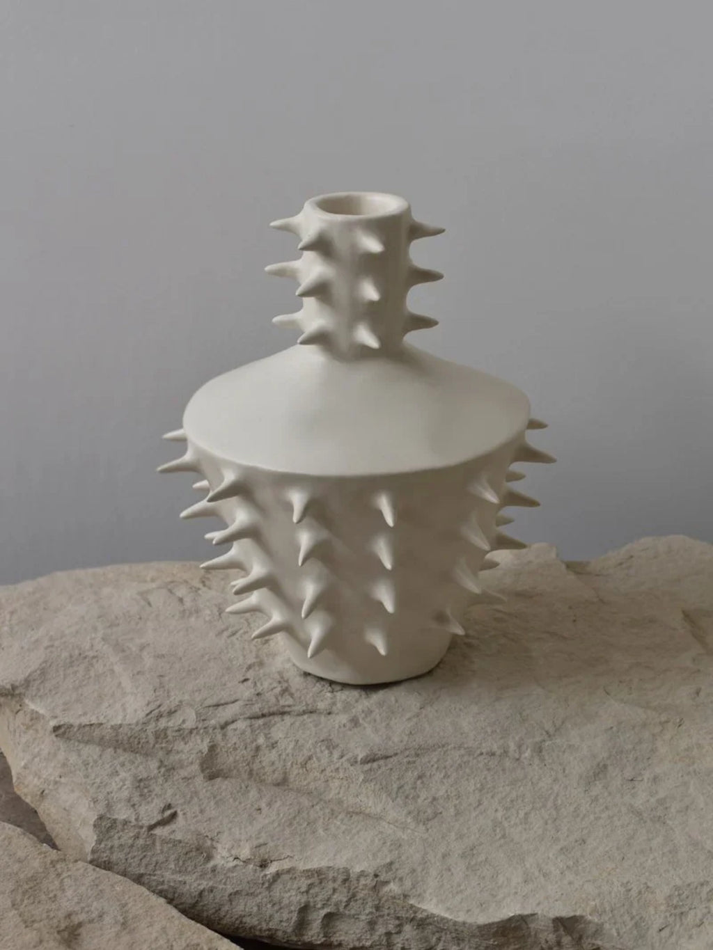 OWO Ceramics x That Cool Living Spikes Vase III, a unique matte white ceramic vase with a textured surface covered in sharp, conical spikes. This handcrafted vase provides a statement piece, ideal for modern, art-forward homes.