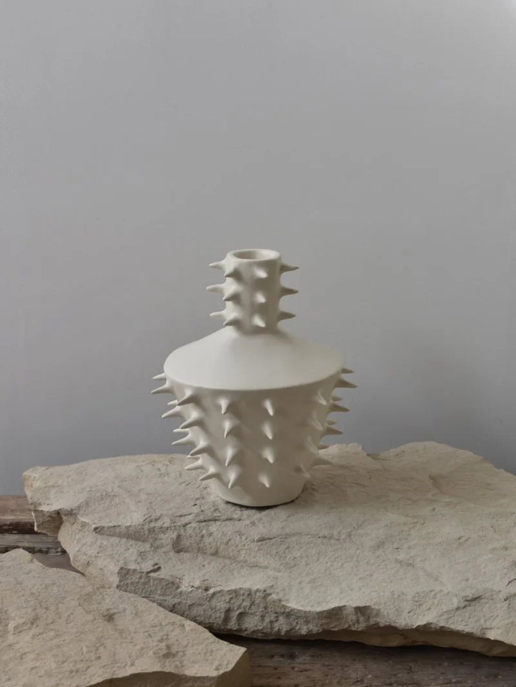 OWO Ceramics x That Cool Living Spikes Vase III, a modern matte white ceramic vase with a rounded body and a textured surface covered in sharp, pointed spikes. This unique and sculptural vase is perfect for those seeking bold, artistic home decor.