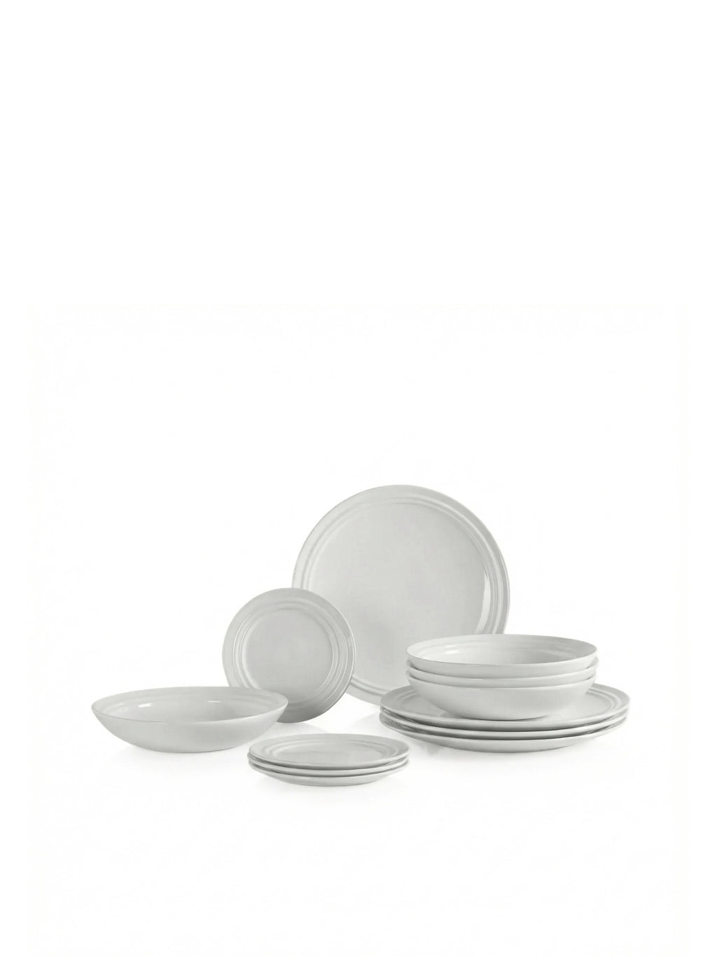 Broste Copenhagen Stevns Dinner Set for 4, a complete contemporary stoneware dinnerware set in a versatile light grey finish, featuring a subtle contrasting rim detail on each piece. This minimalist organic dinnerware includes dinner plates, side plates, deep bowls, and a large serving bowl, all crafted from durable ceramic with a smooth matte texture. Perfect for Scandinavian kitchens, modern dining rooms, or everyday use, offering a rustic yet refined aesthetic.