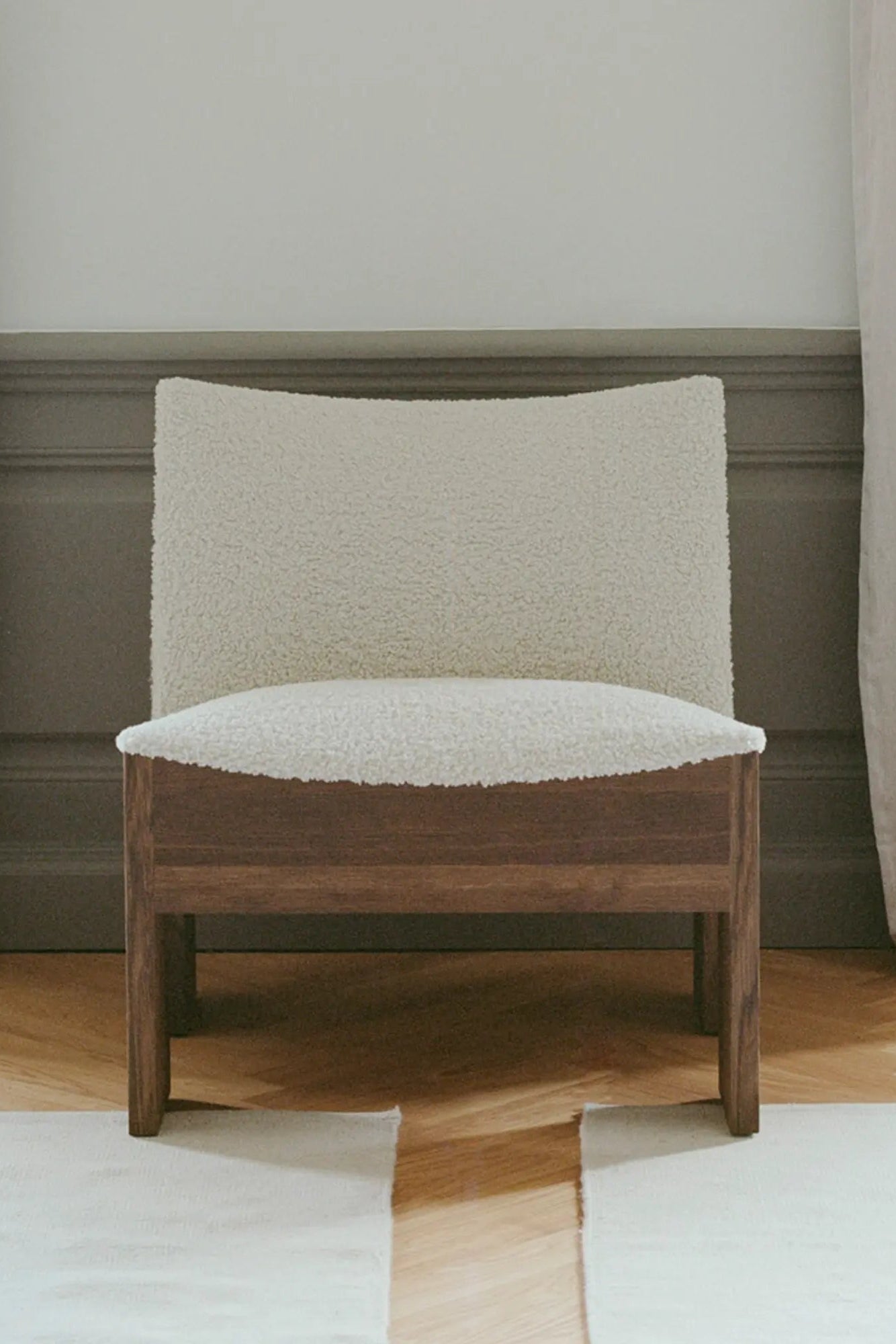  Side view of Tenon armchair showcasing its sleek and elegant design