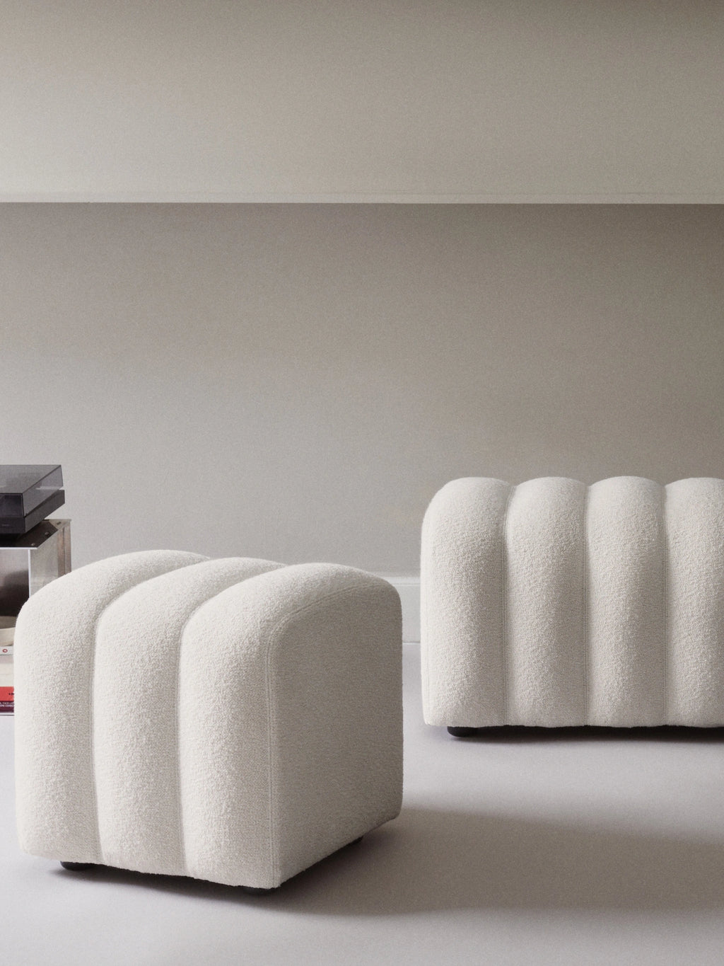 NORR11 Studio Pouf, an elegant cream bouclé fabric pouf featuring a plush, textured channeled design and soft, rounded rectangular silhouette. This versatile contemporary ottoman makes for ideal organic modern accent seating in a minimalist living room or cozy bedroom.