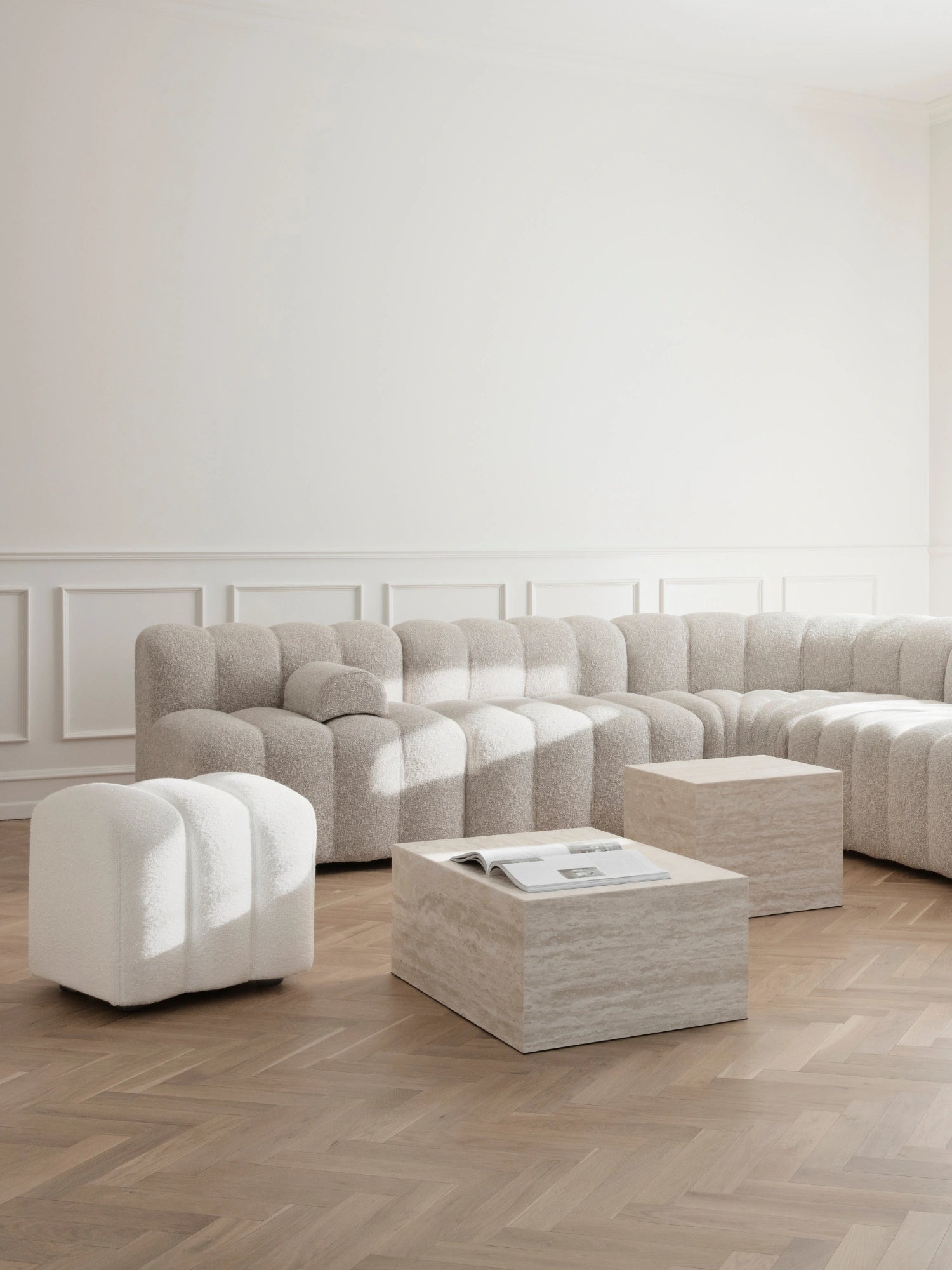 NORR11 Studio Pouf, a white bouclé fabric pouf featuring a soft, plush channel-tufted texture and a distinctive sculptural, rounded silhouette. This organic modern accent piece offers versatile additional seating or a stylish footrest for contemporary living rooms and minimalist bedrooms.