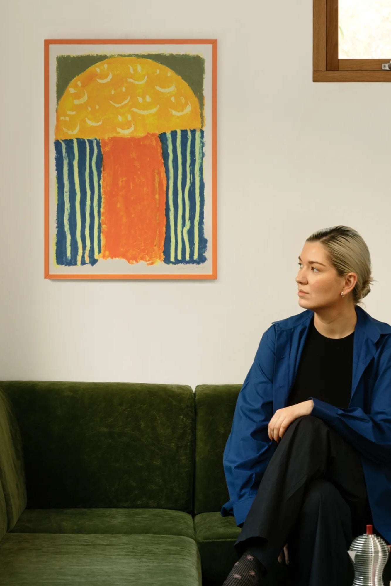 Smiling man wearing a yellow t-shirt and laughing hysterically at a joke