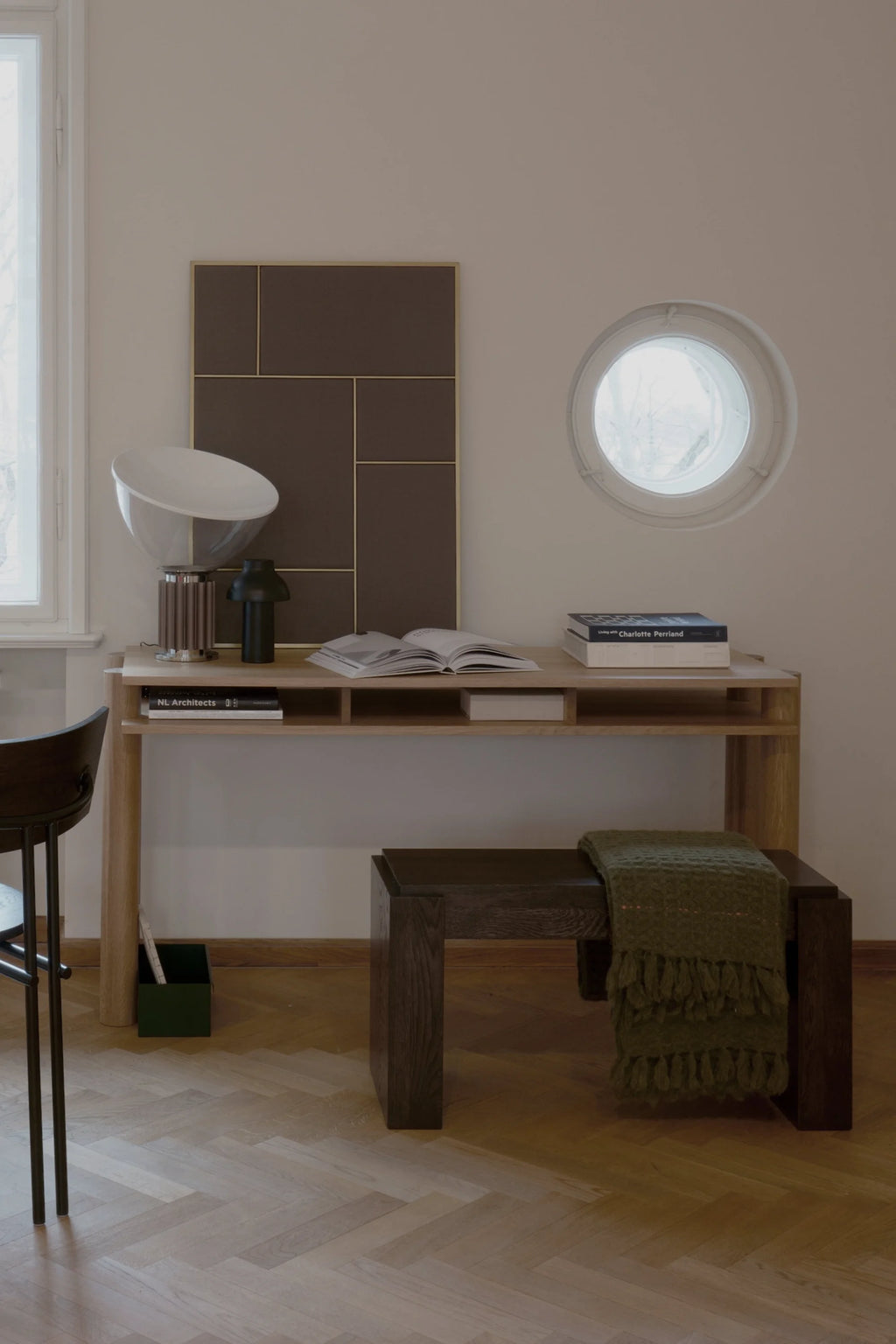 Small home office with a desk, chair, and window.