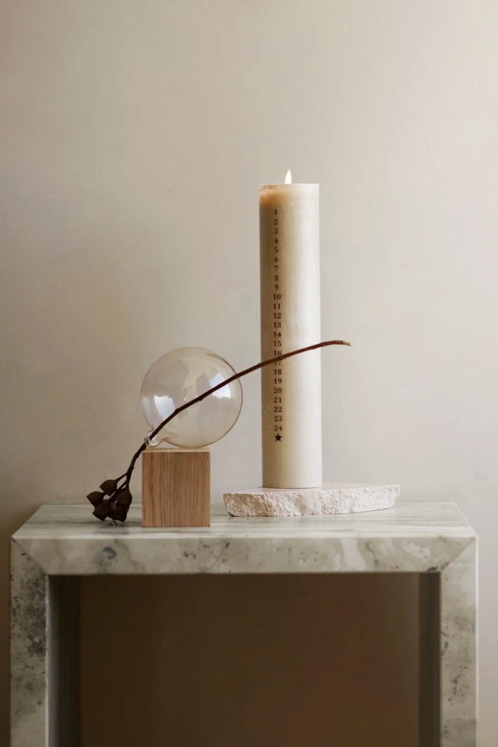 Tine K Cube Travertine Table, a modern minimalist side table crafted from solid, light grey travertine with natural veining and a smooth, polished finish. Its clean, geometric cube shape makes it a versatile accent piece.