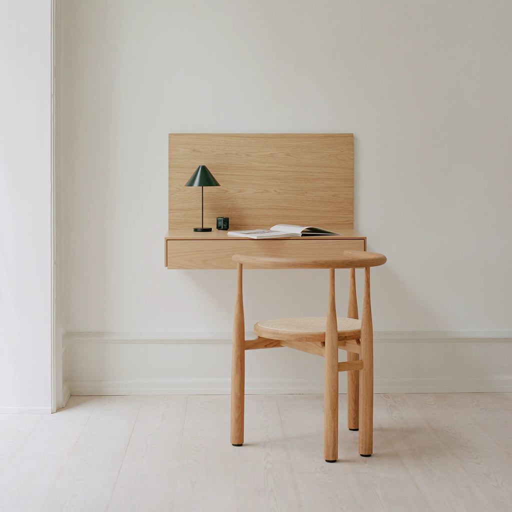 New Works Tana Wall Mounted Desk, a minimalist Scandinavian floating desk crafted from light natural wood with visible grain, featuring a slim profile, a clean rectangular shape, and an integrated drawer for storage. This elegant and space-saving design is perfect as a home office desk, study area, or a stylish entryway console in modern, japandi, or Nordic-inspired interiors.